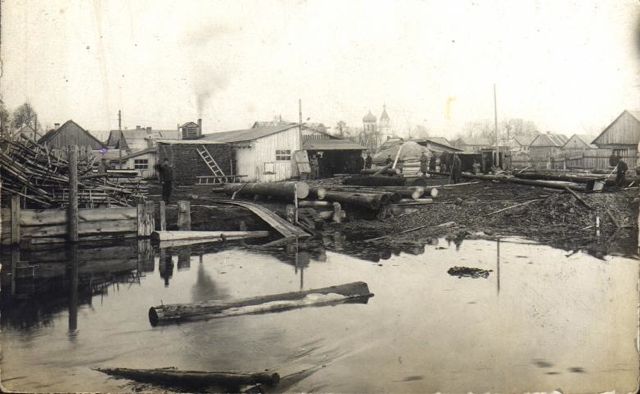 View of
                          wood buildings and Orthodox church from
                          Narewka River